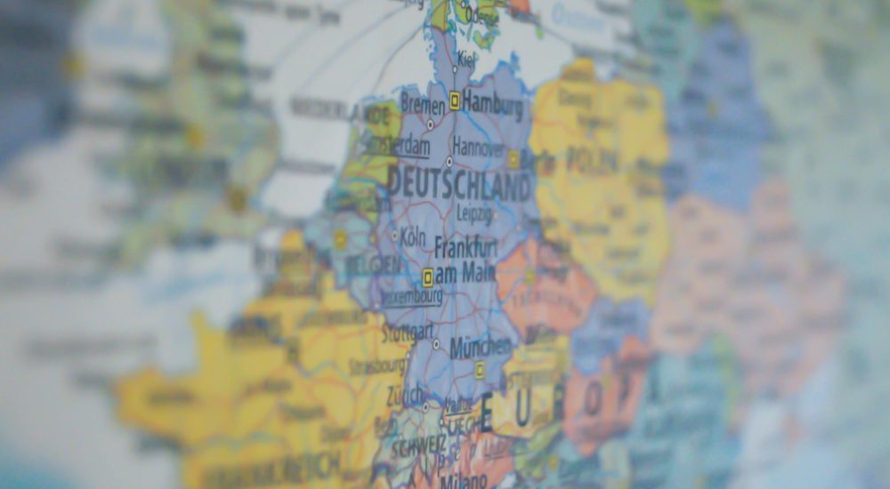 Close-up view of Germany on a colorful world map showing major cities.