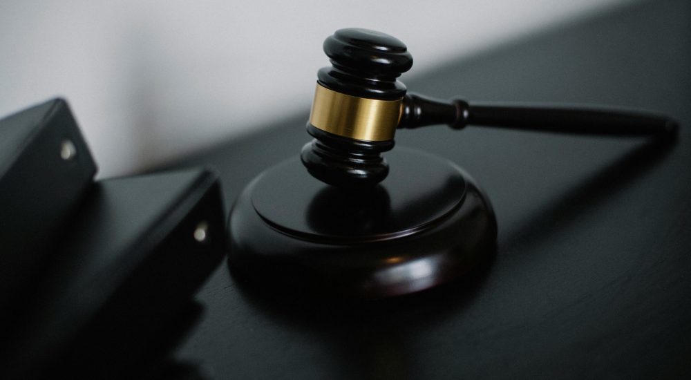 Close-up of a wooden gavel on a desk, symbolizing justice and legal authority.